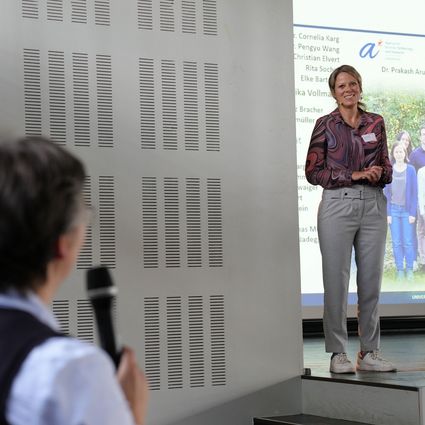 Women on stage for scientific presentation