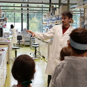 An adult shows the children the lab