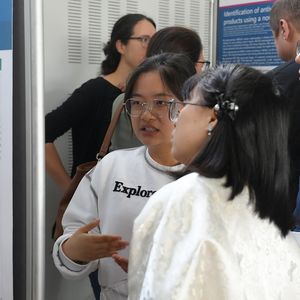 People looking at posters on pinboards