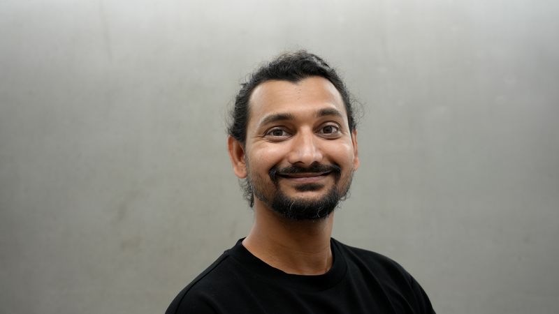 Portrait of Jiteshkumar Deore in front of a gray wall