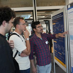 3 people in front of bulletin boards